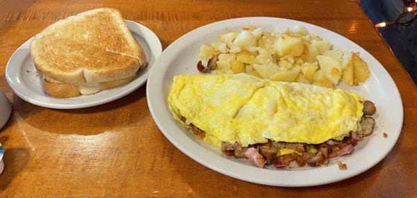 Meat omelette with home fries and sourdough toast