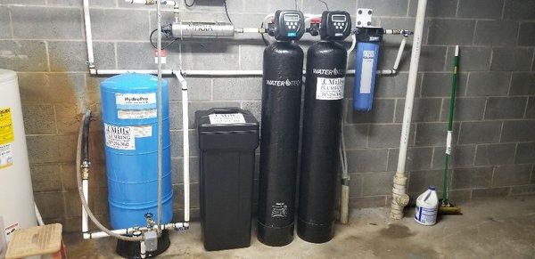 Iron filter, water softener,  and well tank.