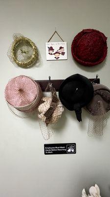 Vintage hats decorate ladies' room.