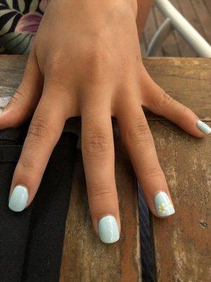 A kid's hand showing light blue nails with a daisy design.