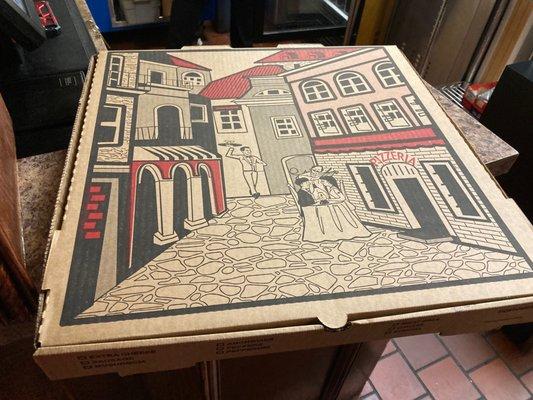 The pizza came in a HUGE box w/ an illustration of a couple being served pizza outdoors while a violinist plays for them in an Italian villa