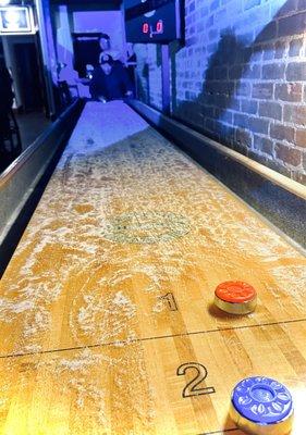 A really cool old shuffle board game in the bar area