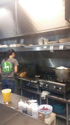 This young lady is preparing fresh fried chicken for the rice