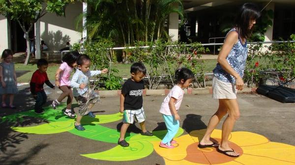 Practicing math and motor skills on the hopscotch.