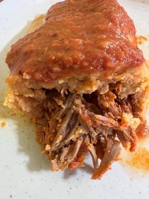 Cross cut of the Pork Tamale with a special request of house hot sauce