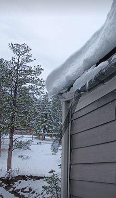 Huge sheets of ice falling from the roof .