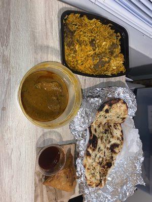 Goat Biryani, 2 Piece Samosa, Goat Curry, Garlic Naan (Roti was eaten but great , and the goat curry come with rice!)