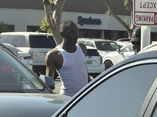 Random guy bothering car owners trying to charge - thinks he's the valet. Unsafe.