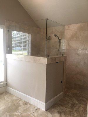 Frameless shower enclosure