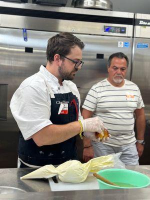 Chef/Owner demonstrating how to create this delicious Sicilian stuffed Brioche with a cherry on top!