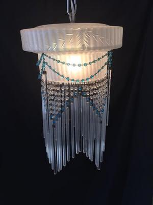 A soft glow from this delicate chandelier from the 1920's.