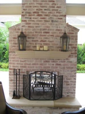 Custom two way brick fireplace, gable covered porch, and decorative concrete patio.