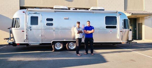 That's Bryan on the left outside of his shop, in front of our Airstream.