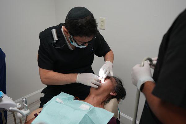 Dr. Tamir working on a dental patient.