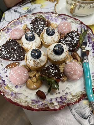 dessert tarts, nuts, petit fours, and dark chocolate covered strawberries