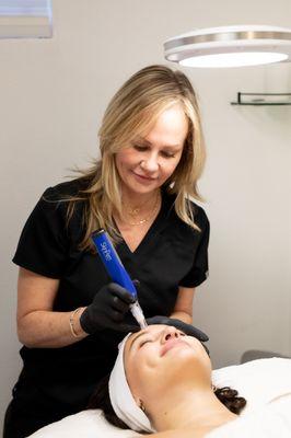 Amy performing microneedling on a client!