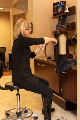 Founder & CEO Maggie Varney working on wigs at the Wigs 4 Kids Wellness Center.