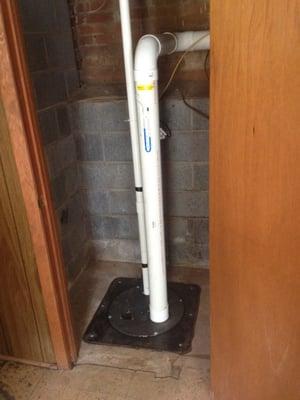 After - New sump pump and properly covered basin with radon mitigation system installed in basement.