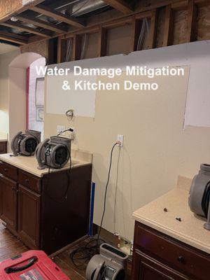 Before picture of the water mitigation & kitchen demo with the drywall & cabinets removed.