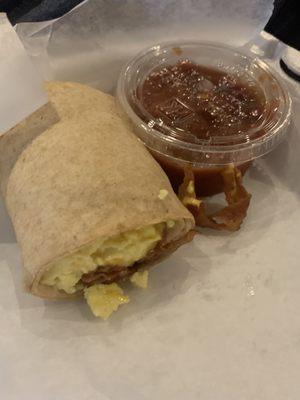 Breakfast burrito with bacon and a side of salsa