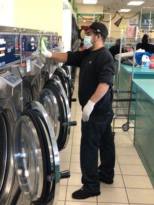 Laundry Attendant keeping the laundromat Clean!