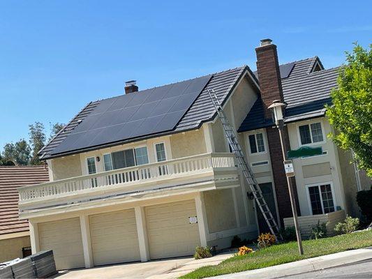 Asphalt shingles installed under the solar panels and concrete tiles around the panels for a flush look.