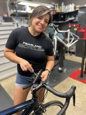 Erica finishing up installing new bar tape on a customers road bike here at Pearland Bicycles