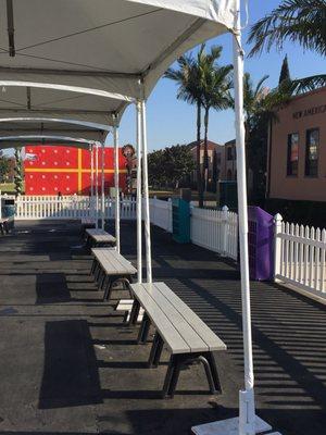 Benches to put on and take off skates. The colored boxes are the shoe storers