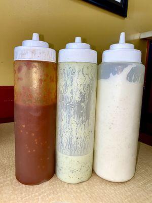 Sauces are all house made! From left to right- their hot sauce, green cilantro sauce, and white sauce.