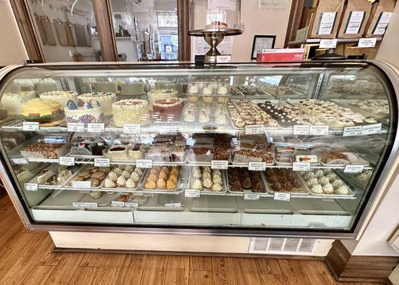 Display case of cakes, cupcakes, and pastries