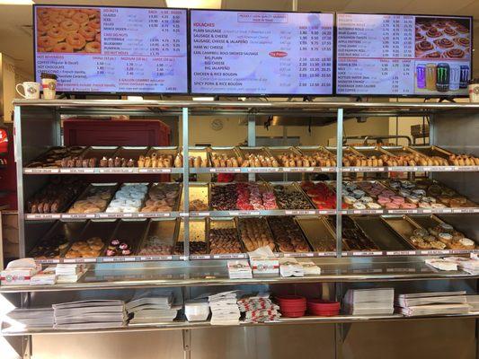 Colorful donuts, top two racks are considered as assorted, last one are pastries!