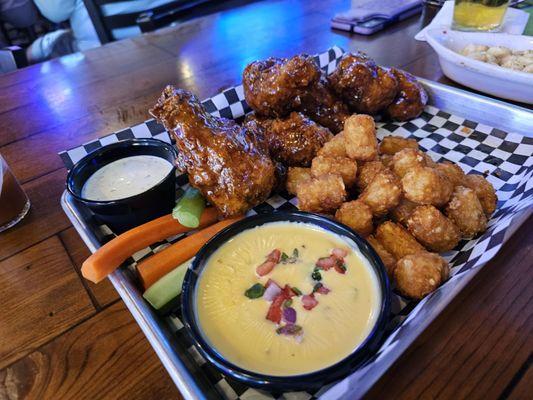 Breaded wing drummets, tots, and a side of queso