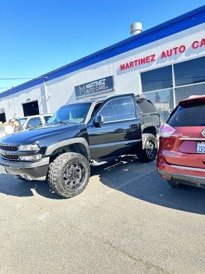 The Tahoe in front of Martinez auto