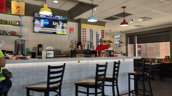 The counter area. The lighted board on the right lets people know when their washing machines are done.