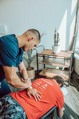 A chiropractic adjustment is performed manually with the doctors hands.