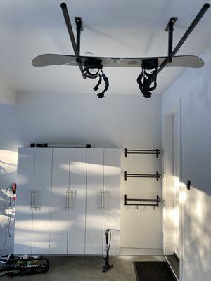 Wall-mounted 3 of the 6ft tall cabinet unit and ceiling mounted snowboard rack, maximizing the use of space above.