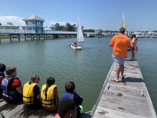 in 2023, we began our collaboration with Cape Charles Splash Camp! Eight weeks over the summer, we take teach this kids sailing.