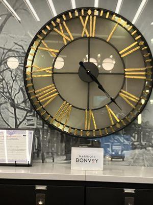 A beautiful clock  featured on the shelf in the lobby