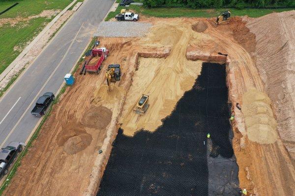 Installing 1' of sand over geogrid for the foundation of a new McDonalds.