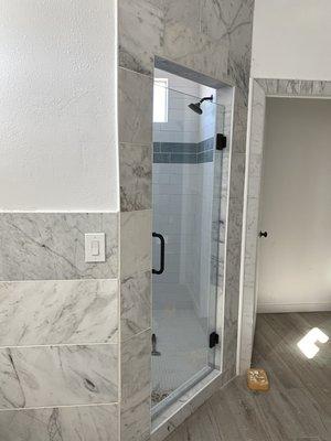 Subway with blue accent tile installed in master bathroom. Along with marble surround