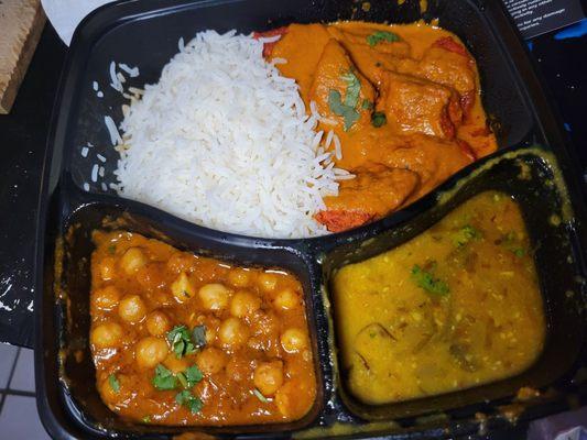 Ghe delicious food. Rice. Chicken tikka misala. I believe bottom left was chick peas and a mildly spicy sauce I would put on my rice.