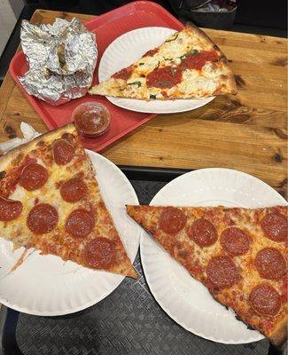 From top to bottom, garlic knots with red sauce, margherita pizza, pepperoni slices