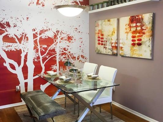 Separate dining area with modern lighting and wood-style flooring.