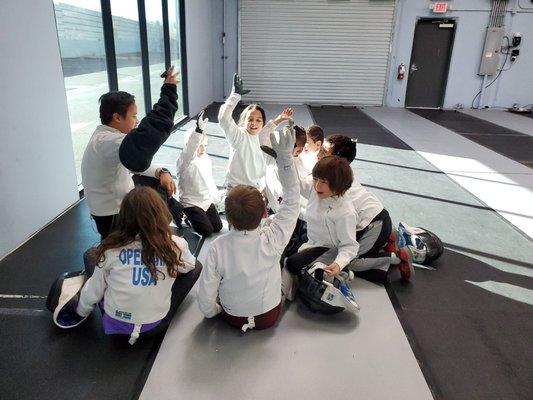 Coach James huddles with the children's class