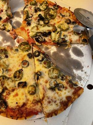 Lou's thin crust. Half sausage and half pepperoni with black olives and jalapeños.