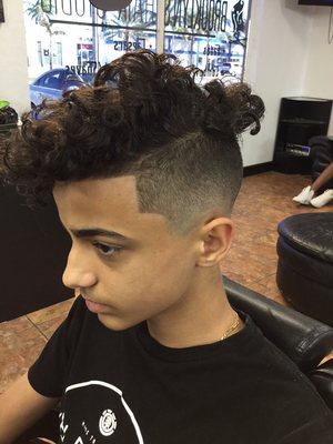 Low fade with curls on top done by the owner Angel