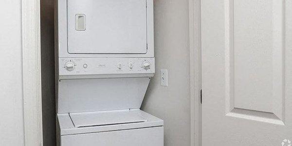 a white washer and dryer in a white room