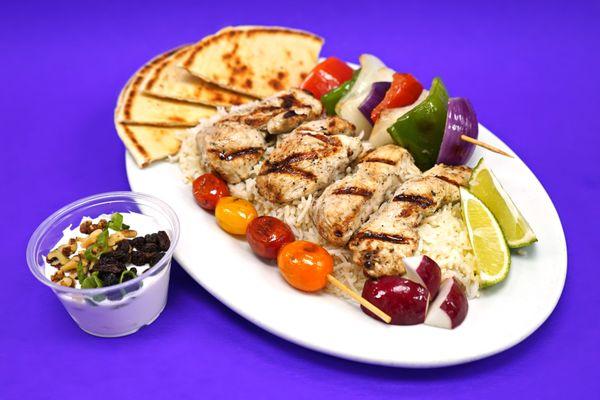 Juicy, marinated chicken skewers grilled to perfection, served with vibrant roasted veggies and warm, fluffy pita bread.