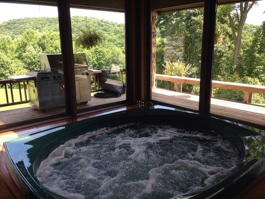 Heated indoor spa tub with panoramic view of grounds