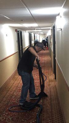 Our service manager cleaning the best western hallways 1 of 3 floors .